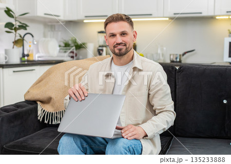 Young man closes laptop after tasks exhales with relief work finished calm relaxed mood success end Young man closes laptop after tasks exhales with relief work finished calm relaxed mood success end 135233888