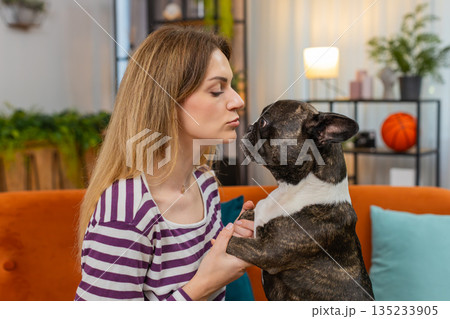 Middle-aged woman with dog face closeup portrait gentle smile sweet bond warm heart happy mood shot Middle-aged woman with dog face closeup portrait gentle smile sweet bond warm heart happy mood shot 135233905