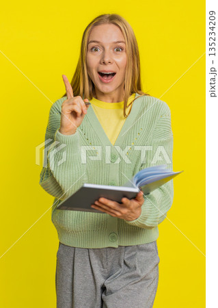 Woman making notes writing down thoughts with pen into notepad notebook diary to do list good idea 135234209