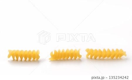 Italian dry fusilli pasta over white background with shadow 135234242