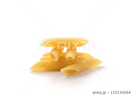 Italian dry penne rigate pasta over white background with shadow Italian dry penne rigate pasta over white background with shadow 135234264