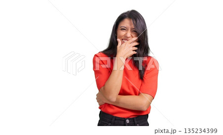 Young woman covering mouth laughing 135234399