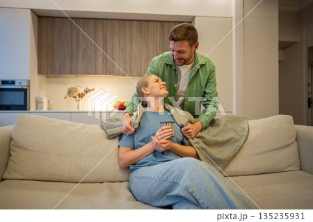 Care and love in modern relationships, man and woman partners spending time together at home. Care and love in modern relationships, man and woman partners spending time together at home. 135235931