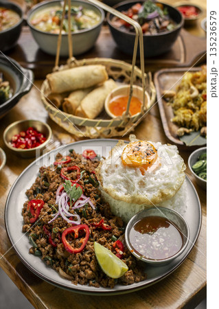 Pad Kra Pao Pork and Holy Basil Stir fry traditional thai food meal on table at restaurant in phuket thailand 135236579