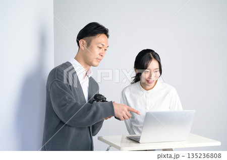 スタジオのパソコンで写真を確認する男女 135236808
