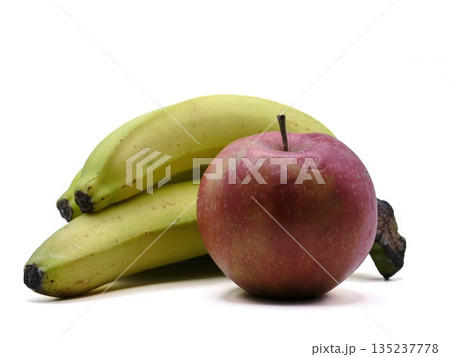 Fresh bananas and red apples set against pure white background emphasizing health and wellness themes Fresh bananas and red apples set against pure white background emphasizing health and wellness themes 135237778
