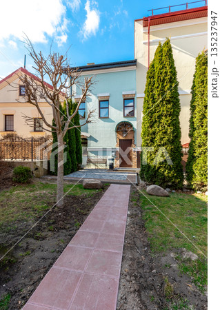 Cozy Residential Courtyard with Pathway and Evergreen Trees Cozy Residential Courtyard with Pathway and Evergreen Trees 135237947