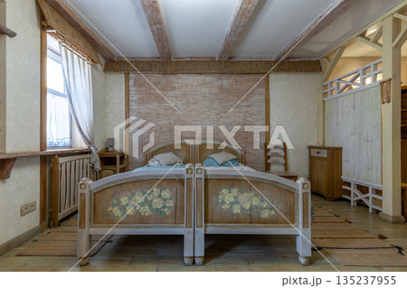 Rustic bedroom interior with hand-painted floral wooden bed Rustic bedroom interior with hand-painted floral wooden bed 135237955