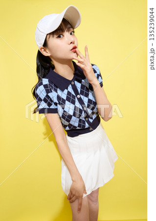 明るい背景でかわいいスポーツウェアを着た若い女性のポートレート 135239044