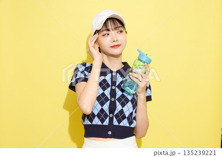 明るい背景でかわいいスポーツウェアを着た若い女性のポートレート 135239221