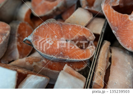 Frozen Salmon Fillets With Skins, Ice Crystals, and Bright Orange Flesh Texture 135239503