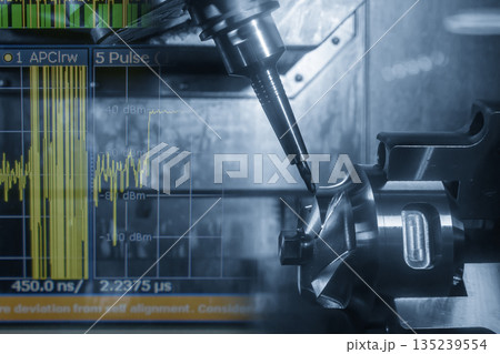 Abstract 5-axis CNC milling machine cutting the automotive part and graph display background in the light blue scene. Abstract 5-axis CNC milling machine cutting the automotive part and graph display background in the light blue scene. 135239554