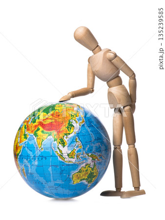 Figurine human hand touches the globe 135239585