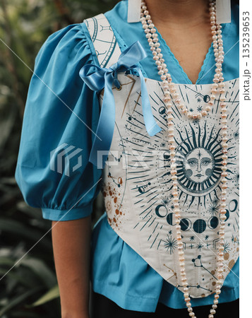 Fashion photograph emphasizing sun motif with jewelry and embroidery Fashion photograph emphasizing sun motif with jewelry and embroidery 135239653