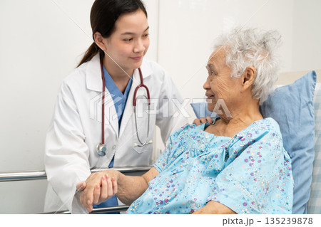 Asian doctor checking and treat elderly woman patient health in hospital. Asian doctor checking and treat elderly woman patient health in hospital. 135239878