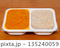 Ready-made dinner dish with rice on a plastic tray. 135240059