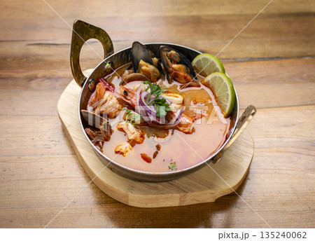mixed seafood tom yum thai curry soup indoors ina a phuket thailand restaurant mixed seafood tom yum thai curry soup indoors ina a phuket thailand restaurant 135240062