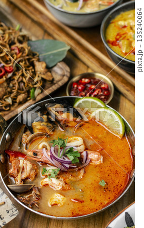 mixed seafood tom yum thai curry soup indoors ina a phuket thailand restaurant mixed seafood tom yum thai curry soup indoors ina a phuket thailand restaurant 135240064