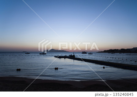 The sun rises over the sea from behind Tiran Island in Egypt 135240845
