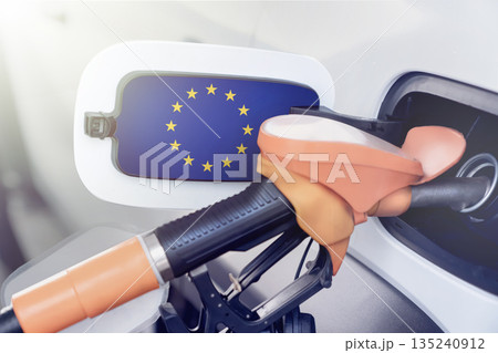The flag of the European Union on the lid of the gas tank of a car at a gas station. High prices for diesel fuel, gasoline and gas at gas stations in the European Union, shortage of combustible The flag of the European Union on the lid of the gas tank of a car at a gas station. High prices for diesel fuel, gasoline and gas at gas stations in the European Union, shortage of combustible 135240912