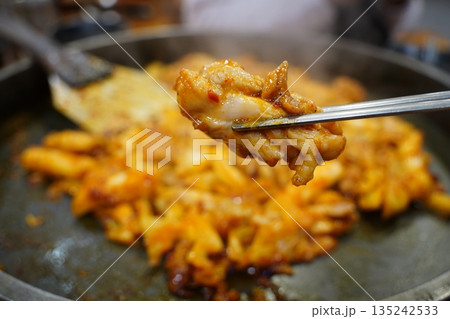 Sizzling Korean spicy stir fried chicken (Dak-galbi) with vegetables on a hot iron plate Sizzling Korean spicy stir fried chicken (Dak-galbi) with vegetables on a hot iron plate 135242533