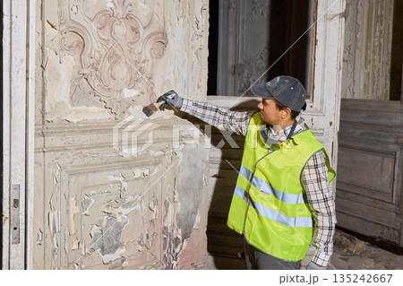 Conservation team member photographs detailed plaster surface evidence 135242667
