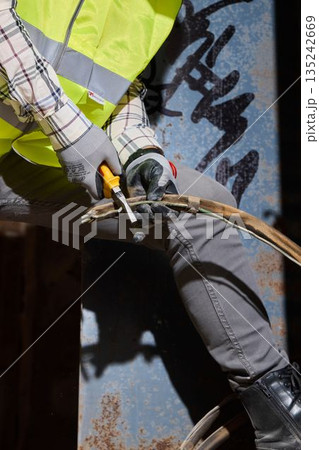 Fabricator cutting metal with angle grinder during renovation Fabricator cutting metal with angle grinder during renovation 135242669