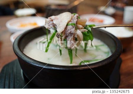 Hearty Korean Sundae-guk (blood sausage soup) with rice in a hot stone pot 135242675