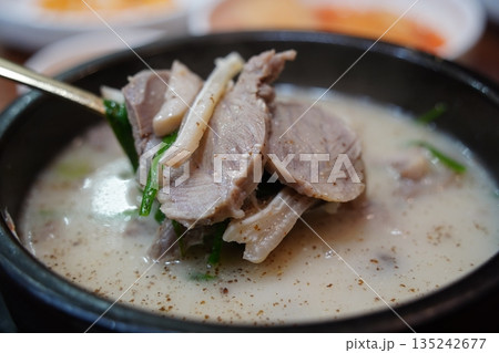 Hearty Korean Sundae-guk (blood sausage soup) with rice in a hot stone pot 135242677