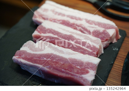 Fresh raw pork belly slices for cooking, perfect for Korean barbecue or roasting 135242964