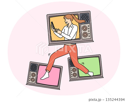 Woman with televisions holds phone showing love for watching online videos in mobile applications 135244394