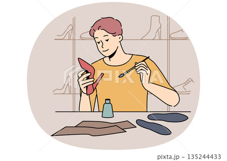 Man shoemaker holding women shoes sitting at table, repairing or making handmade footwear. 135244433