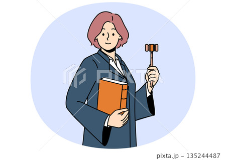 Woman judge with wooden claw and constitution in hands is ready to announce fair legal decision 135244487