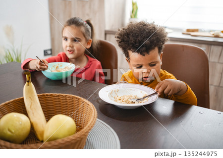 Family enjoying breakfast together in a cozy setting Family enjoying breakfast together in a cozy setting 135244975