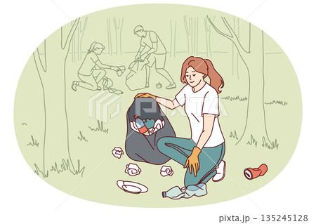 Woman volunteer collects garbage in bag, cleaning park from plastic non-degradable waste Woman volunteer collects garbage in bag, cleaning park from plastic non-degradable waste 135245128