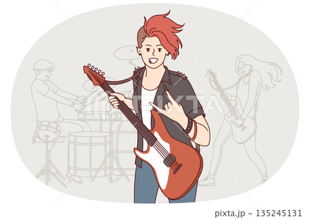 Girl rock musician plays guitar and makes gesture goat enjoying performance at heavy music concert 135245131