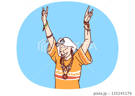 Mature hippie woman in fashionable clothes and accessories enjoys life dancing at parties 135245179