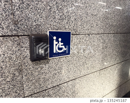 Call for help button next to disabled sign and braille text for visually impaired. Comprehensive solution for people with disabilities. Creating accessible locations for wheelchair users 135245187