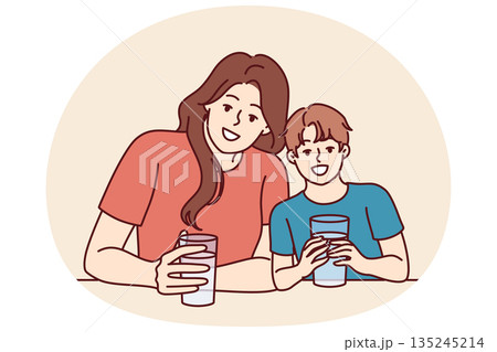 Happy mom and son drink water from transparent glasses and smile enjoying clean refreshing beverage Happy mom and son drink water from transparent glasses and smile enjoying clean refreshing beverage 135245214