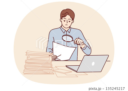 Man tax inspector is sitting in office doing paperwork using magnifying glass to check contract 135245217