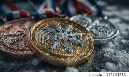 Winter sports medals with gold silver bronze awards on snowy surface celebrating victory achievement and competition success 135245218