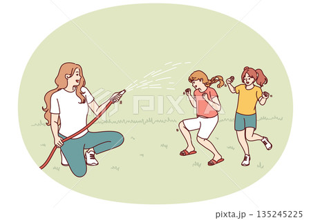Happy mother watering laughing children with hose enjoying summer walk in park or backyard Happy mother watering laughing children with hose enjoying summer walk in park or backyard 135245225