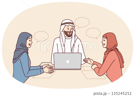 Business meeting with people in arabic clothes and hijabs sitting at office table with laptop Business meeting with people in arabic clothes and hijabs sitting at office table with laptop 135245252