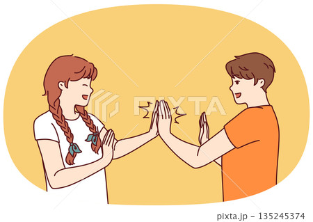 Children play hand-clapping laughing and enjoying teenage friendship and happy childhood 135245374