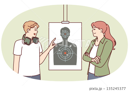 Man teaches woman to shoot at targets with rifle range of firearms for admission to police academy 135245377