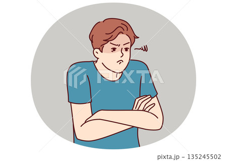Angry man with hands folded in front of chest demonstrates envy and indignation. Angry man with hands folded in front of chest demonstrates envy and indignation. 135245502