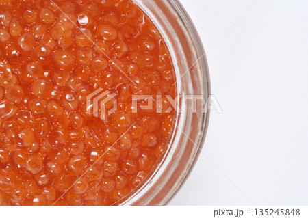 Red trout caviar in a glass jar 135245848