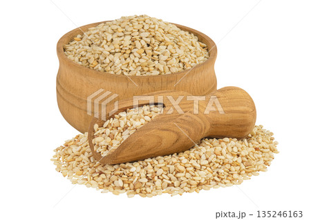 Sesame seeds in wooden bowl and scoop isolated on white background Sesame seeds in wooden bowl and scoop isolated on white background 135246163