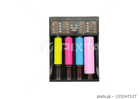 Rechargeable batteries in a battery charger. Four batteries in a charger. NI-MH and LI-MH battery. Rechargeable batteries in a battery charger. Four batteries in a charger. NI-MH and LI-MH battery. 135247127