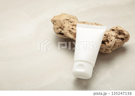 White cream tube on stone on light background. Skincare handmade beauty product. 135247138